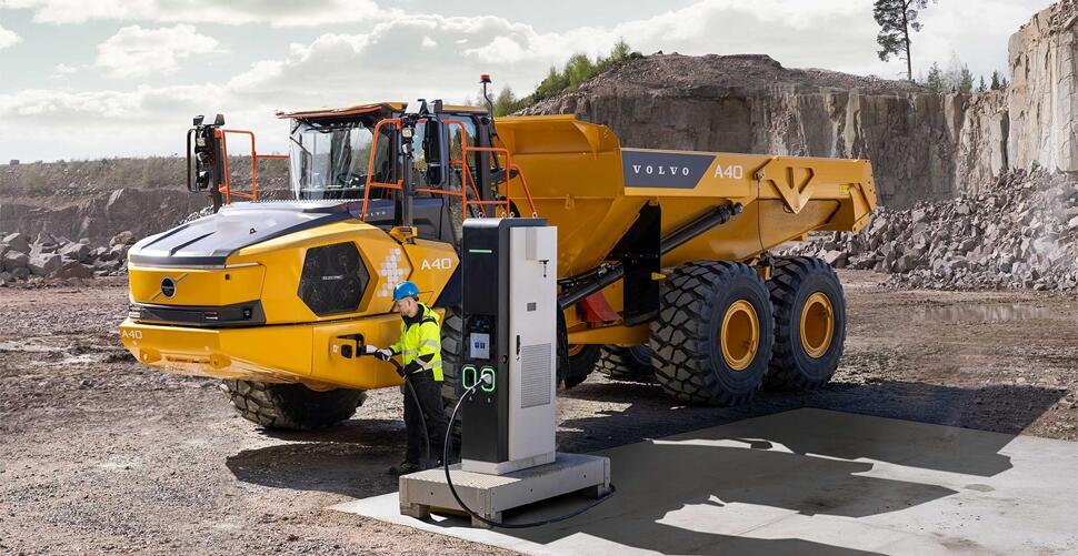 Volvo A40 Electric Being Hooked Up to a Charger by a Worker (IMAGE - Volvo)